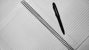 Overhead shot of an open notebook with a pen, ideal for writing or journaling concepts.