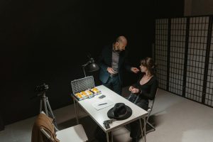 An intense interrogation with evidence on the table, showcasing a crime scene.