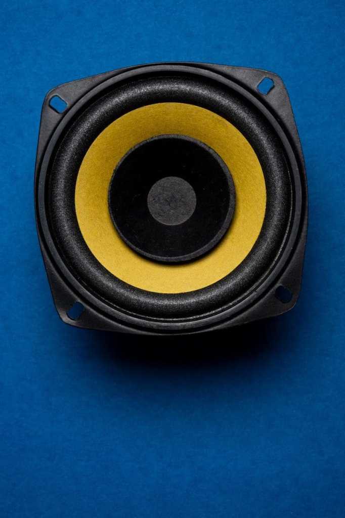 a close up of a speaker on a blue surface